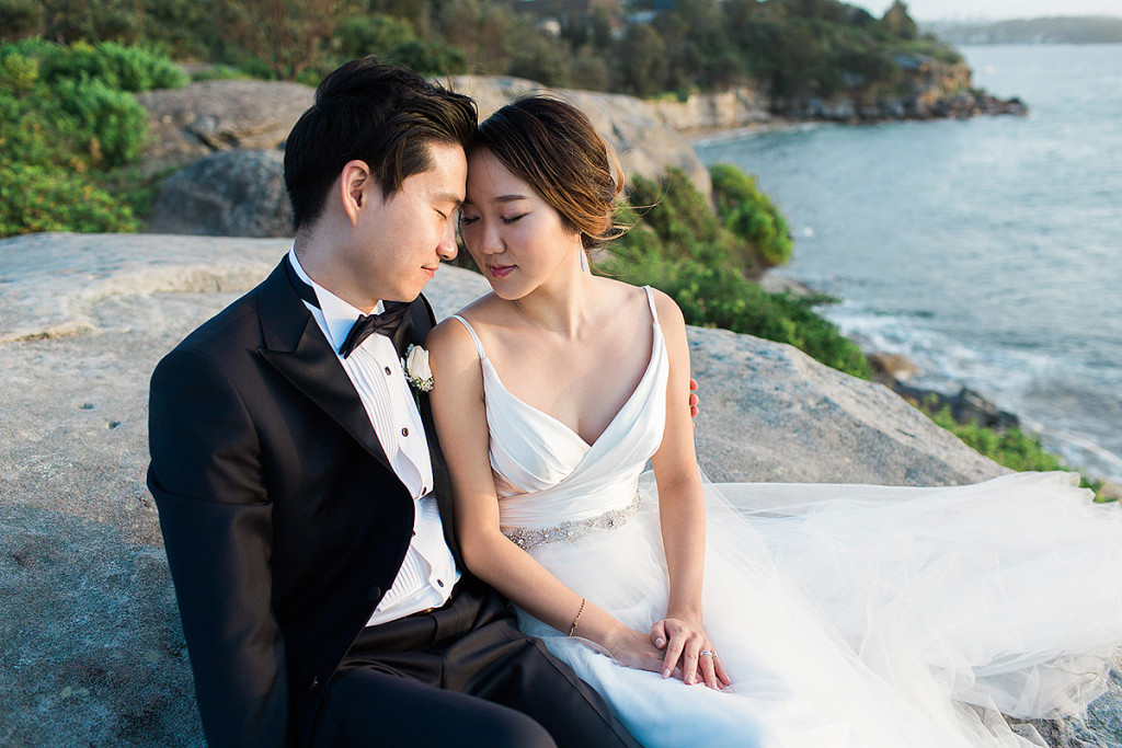 058-romantic-moment-for-bride-and-groom-at-camp-cove-headlands