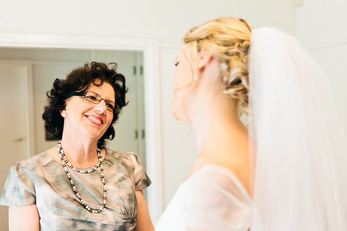 mother-of-the-bride-looks-at-daughter-in-her-dress
