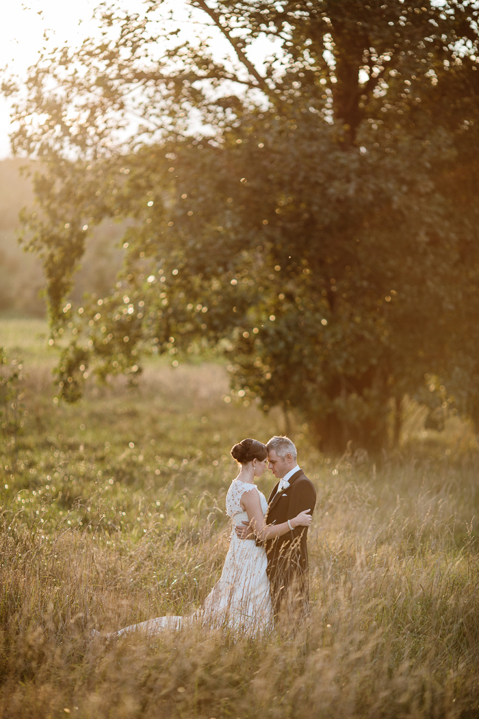 bride-and-groom-in-open-field-sunset