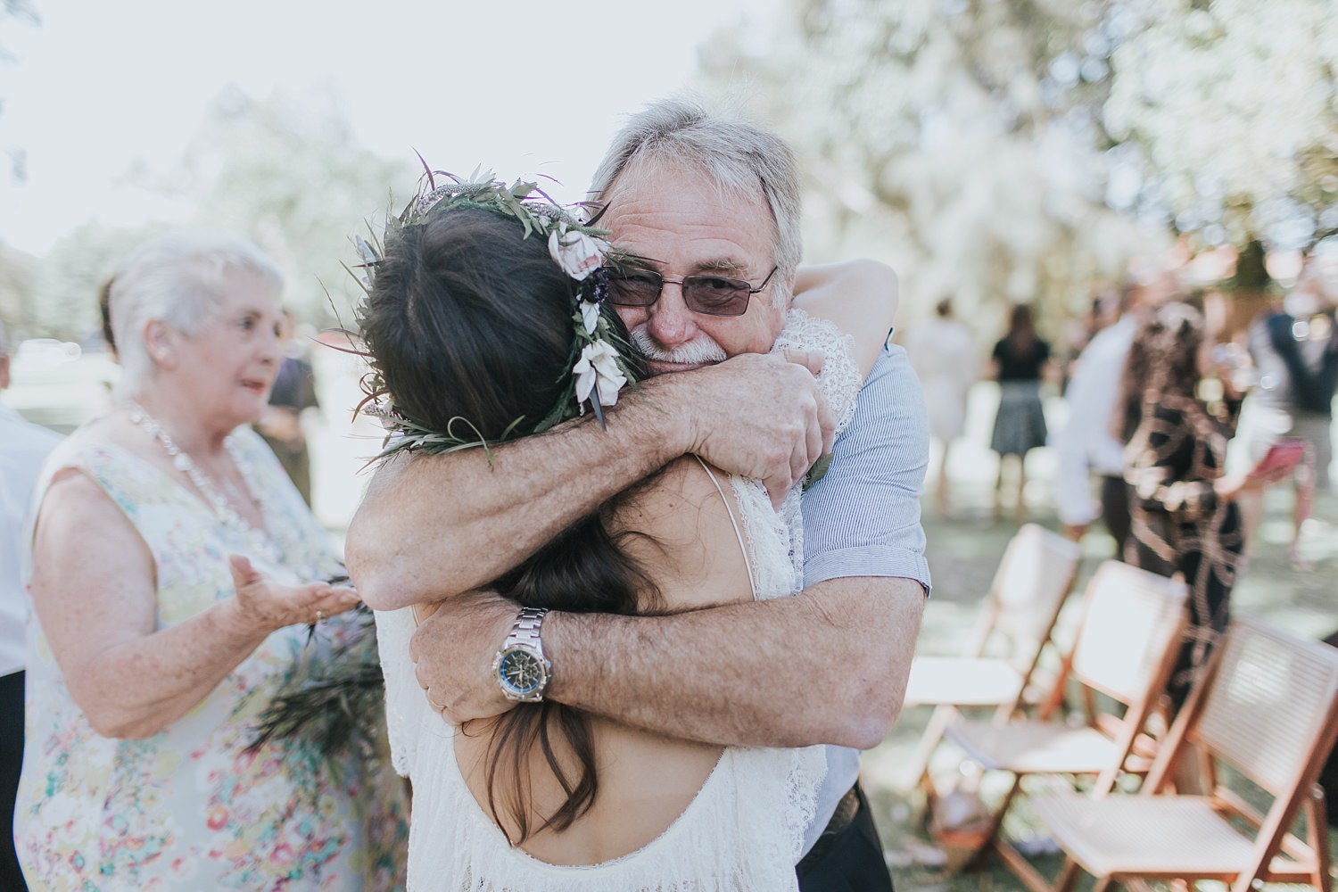 father of the bride embraces his daughter