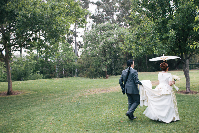 groom-helps-his-bride-with-her-wedding-dress