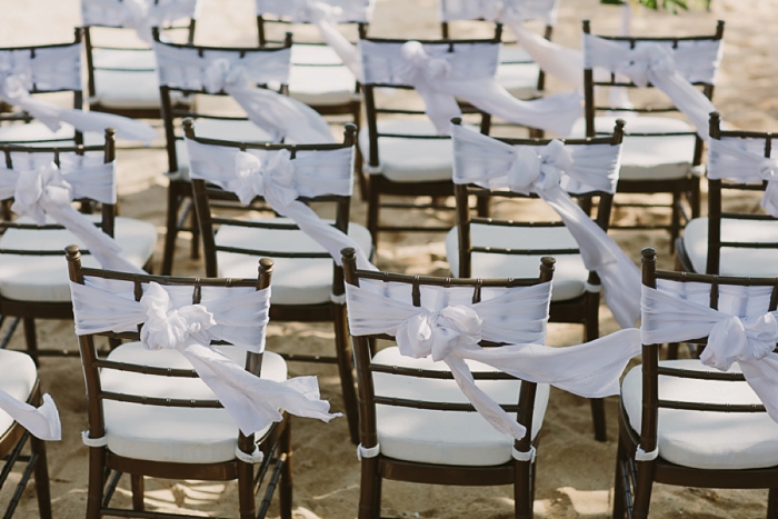 Beach Wedding in Fiji with chair sashes blowing in the breeze