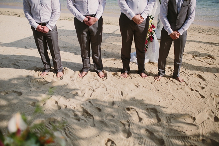 Barefoot groom on beach wedding