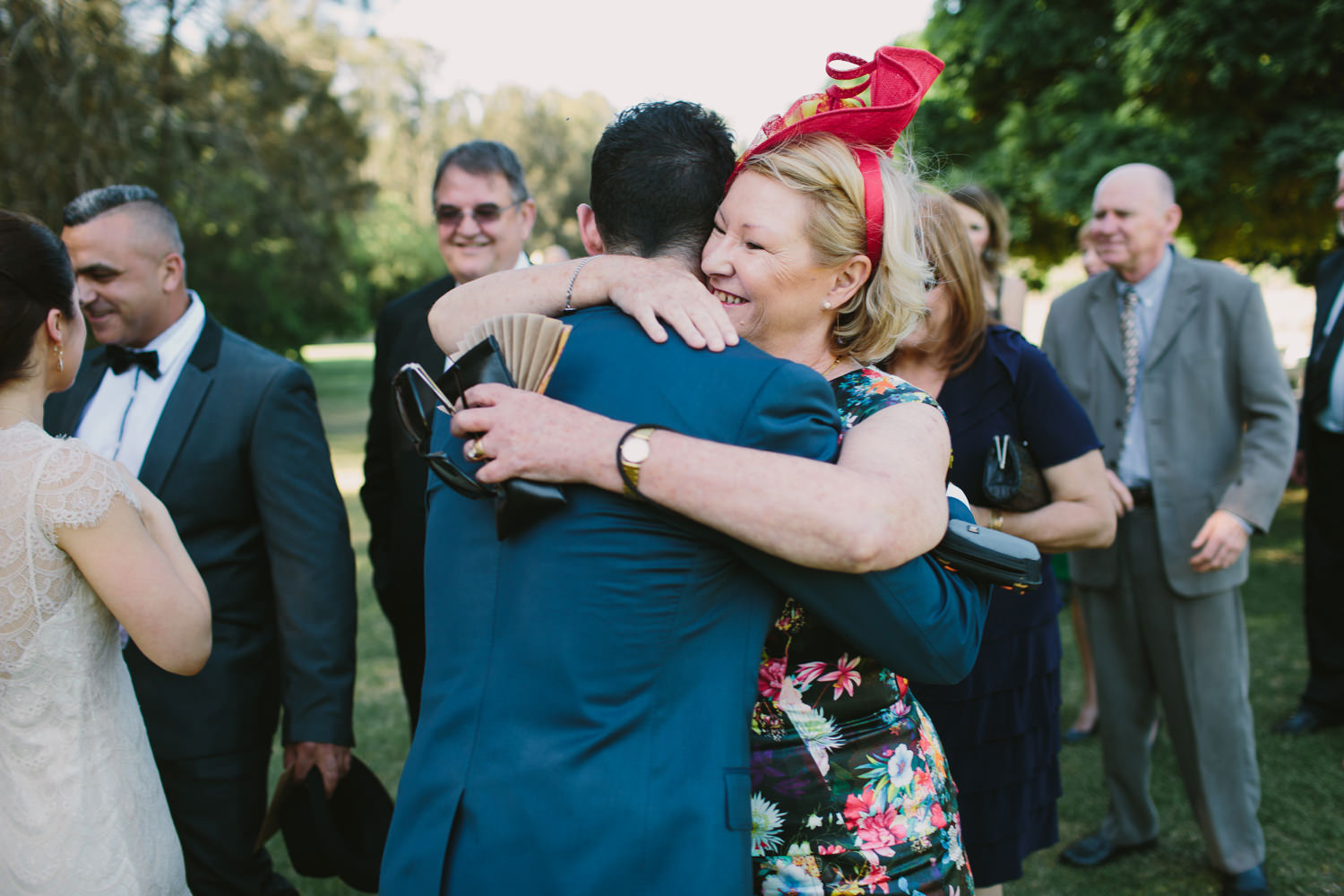 Mother of the groom hugs her son after wedding ceremony
