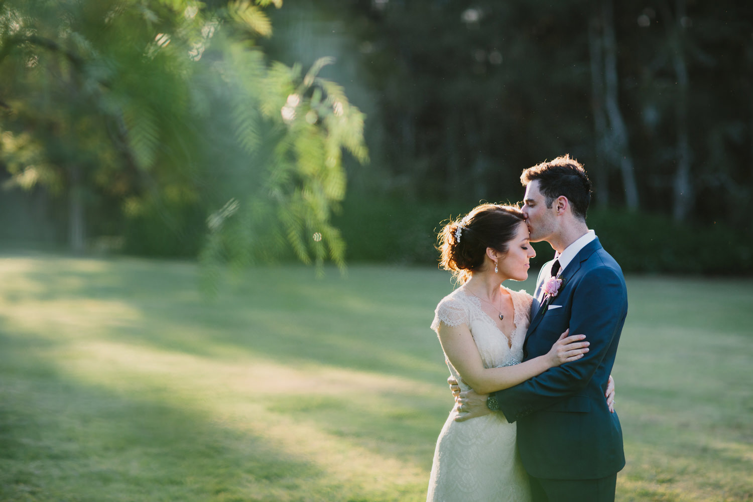 Bride and groom kiss in the sun after Hunter Valley wedding