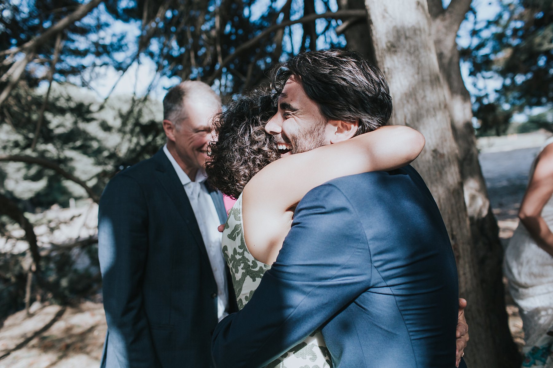 excited hugs and tears at wedding ceremony