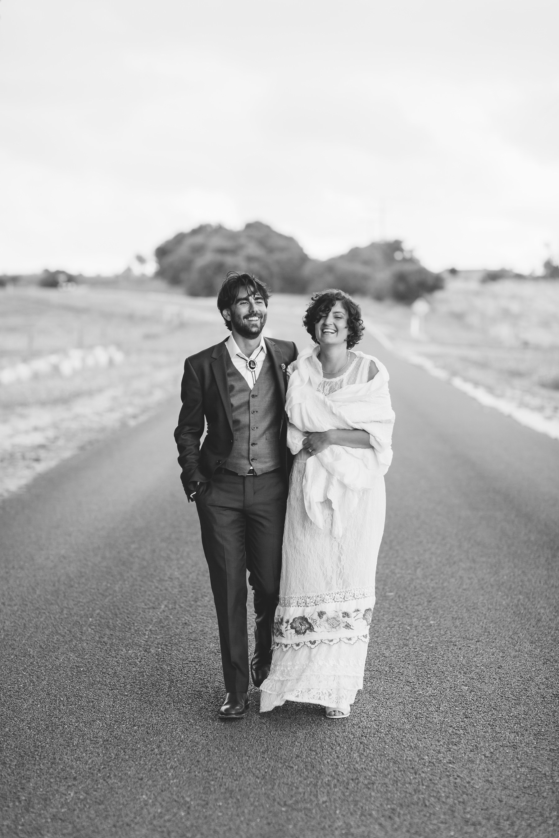 bride & groom walking down the road together
