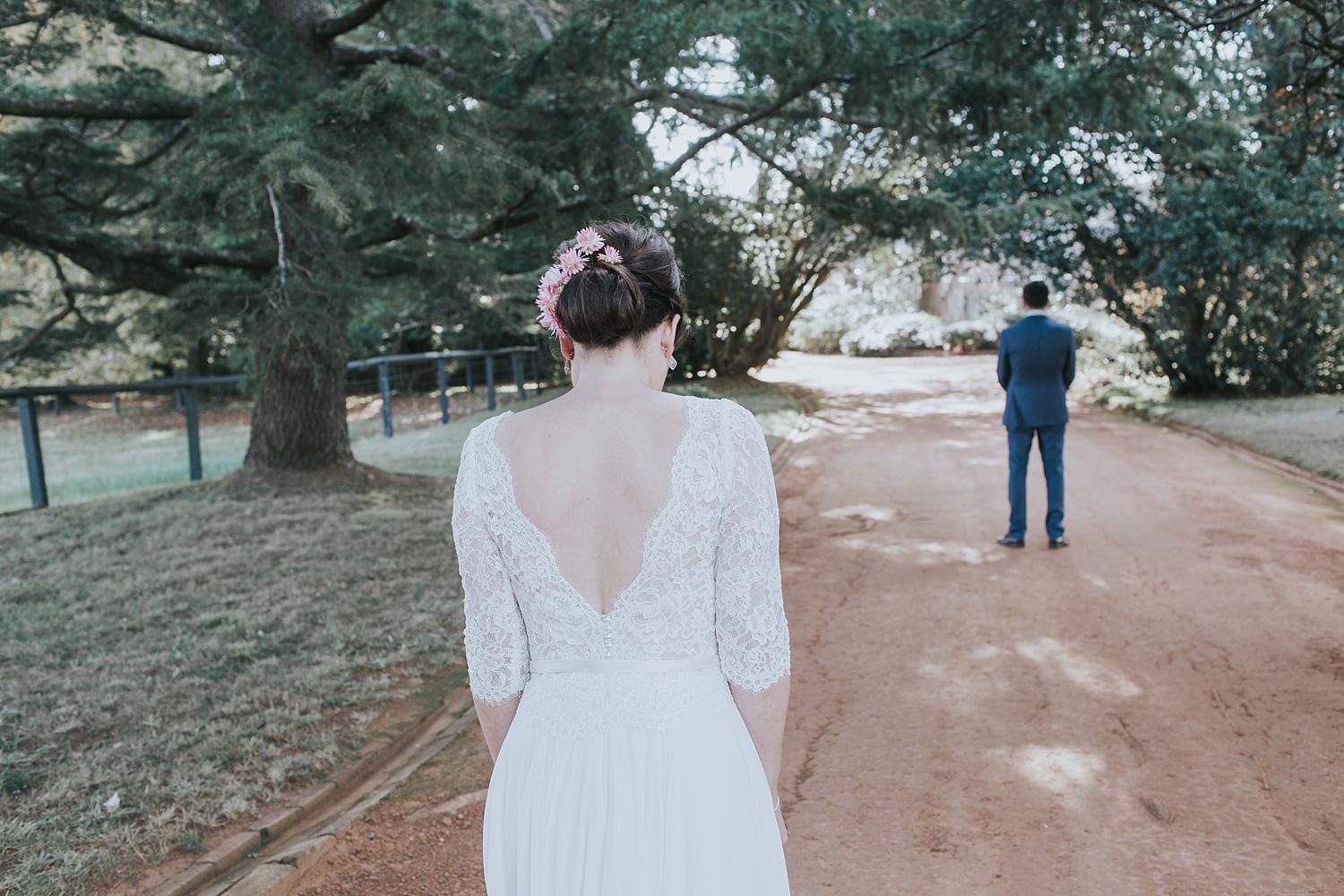 bride approaches her groom on bendooley estate driveway