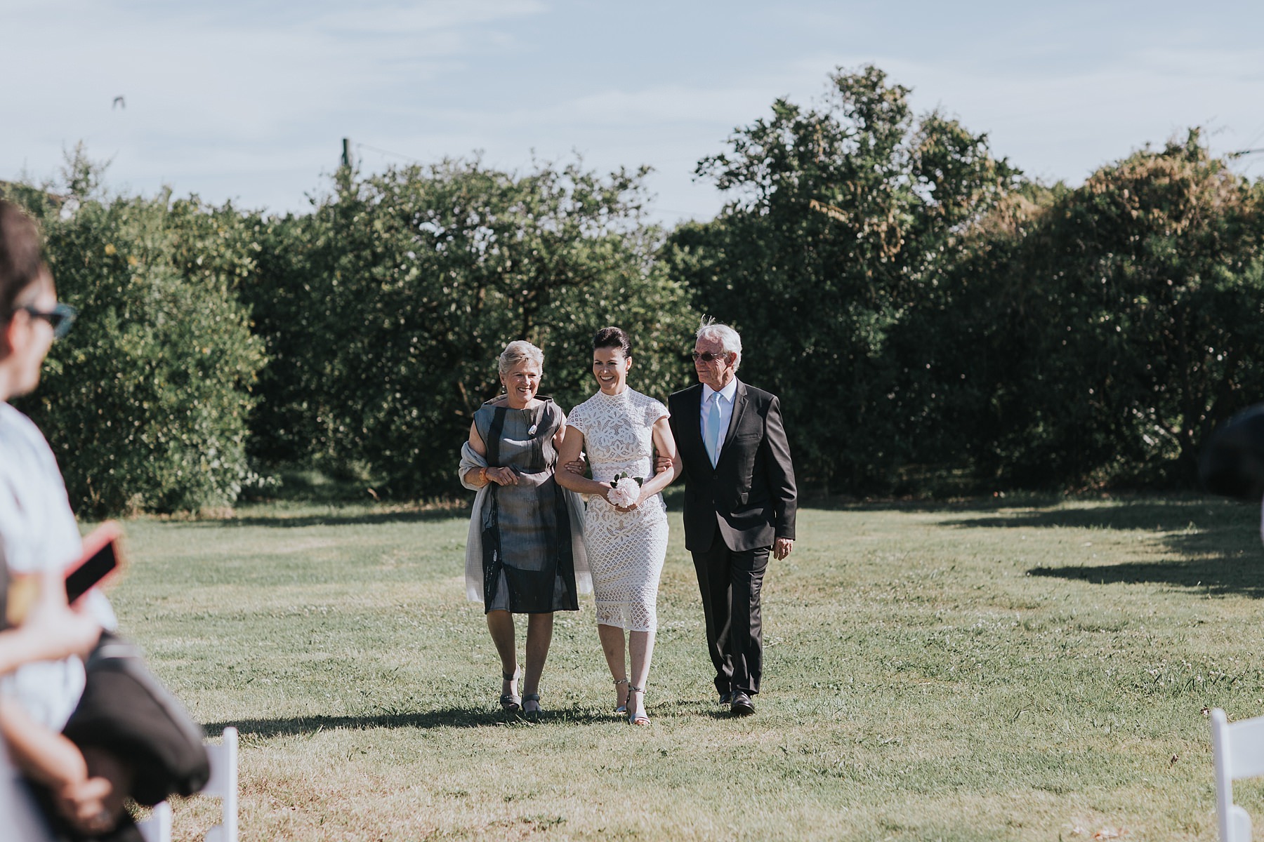 bride walked down the aisle by her parents at cornwallis house