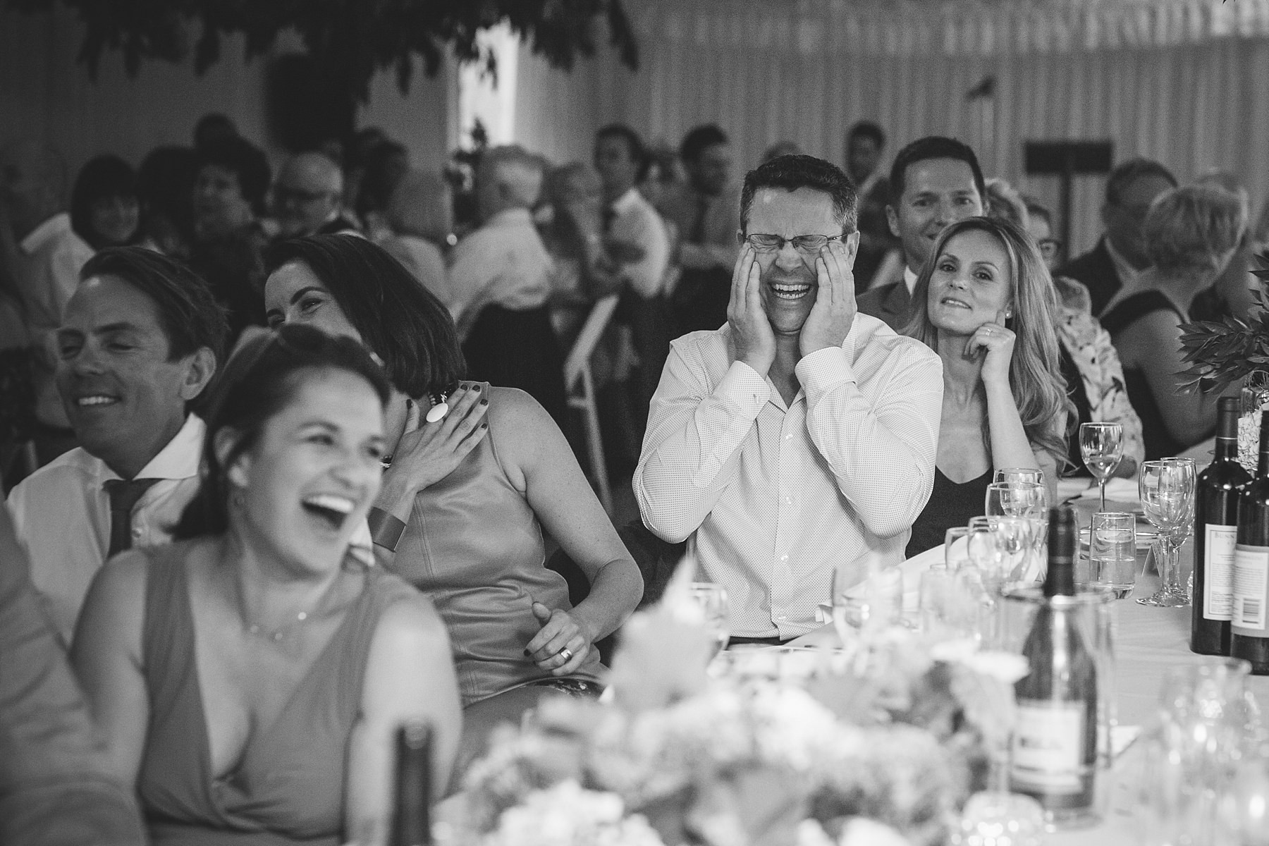 guests enjoying speeches at wedding reception