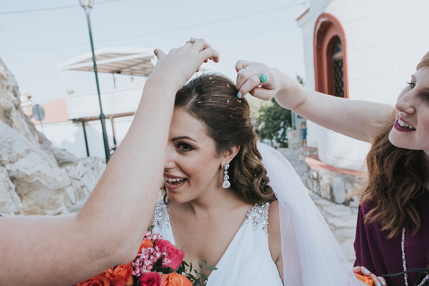 rice being removed from brides hair in skiathos