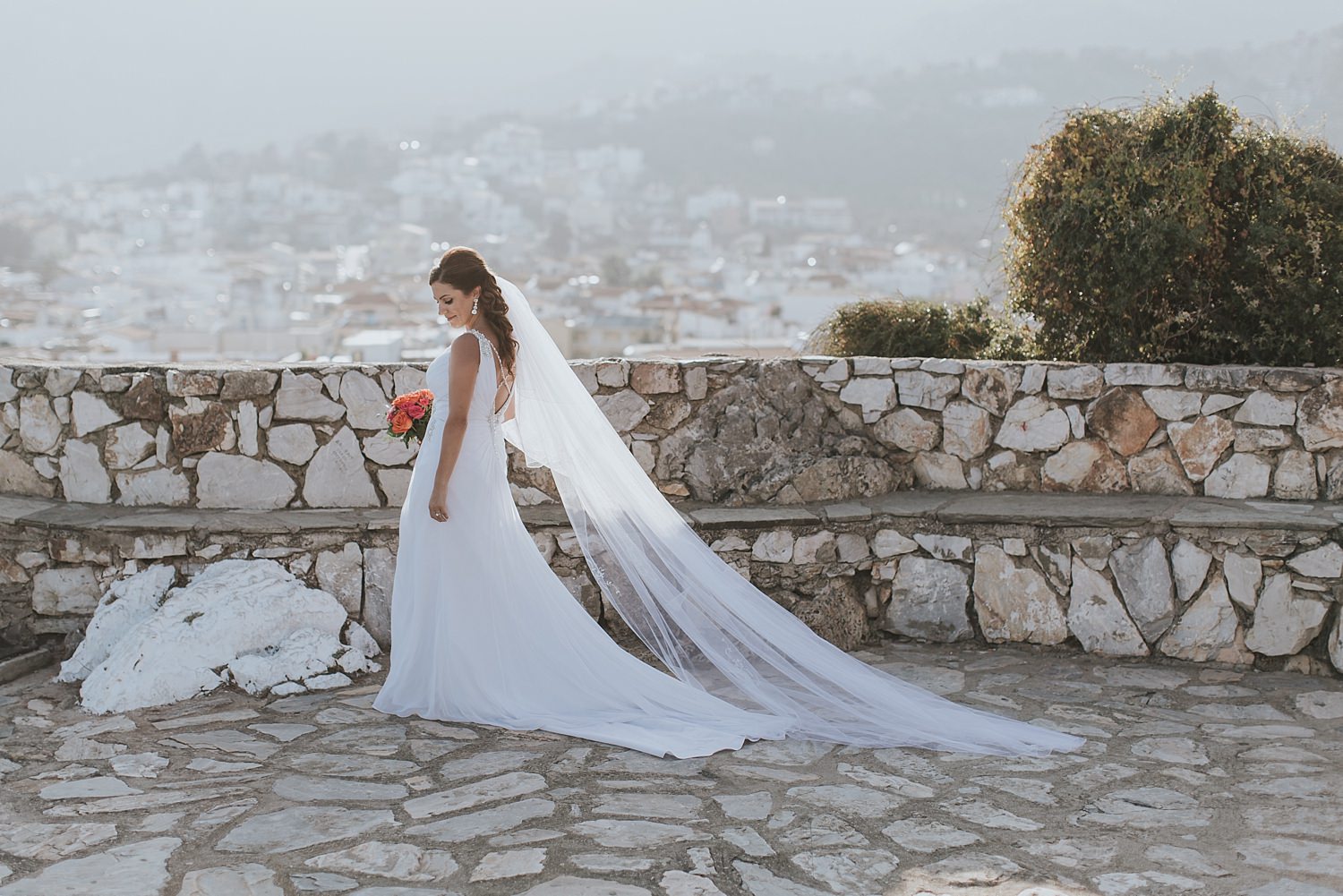 bride walks into the sun in greek islands wedding