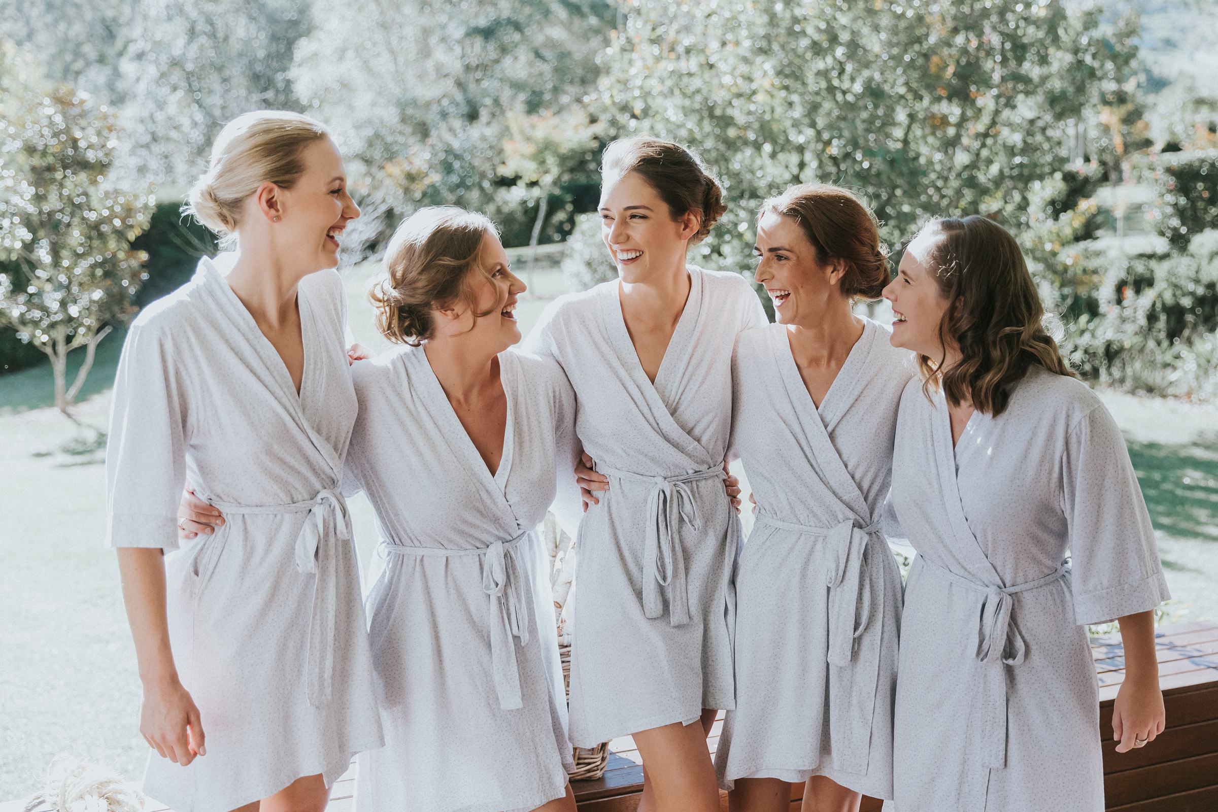 bride and bridesmaids in matching robes