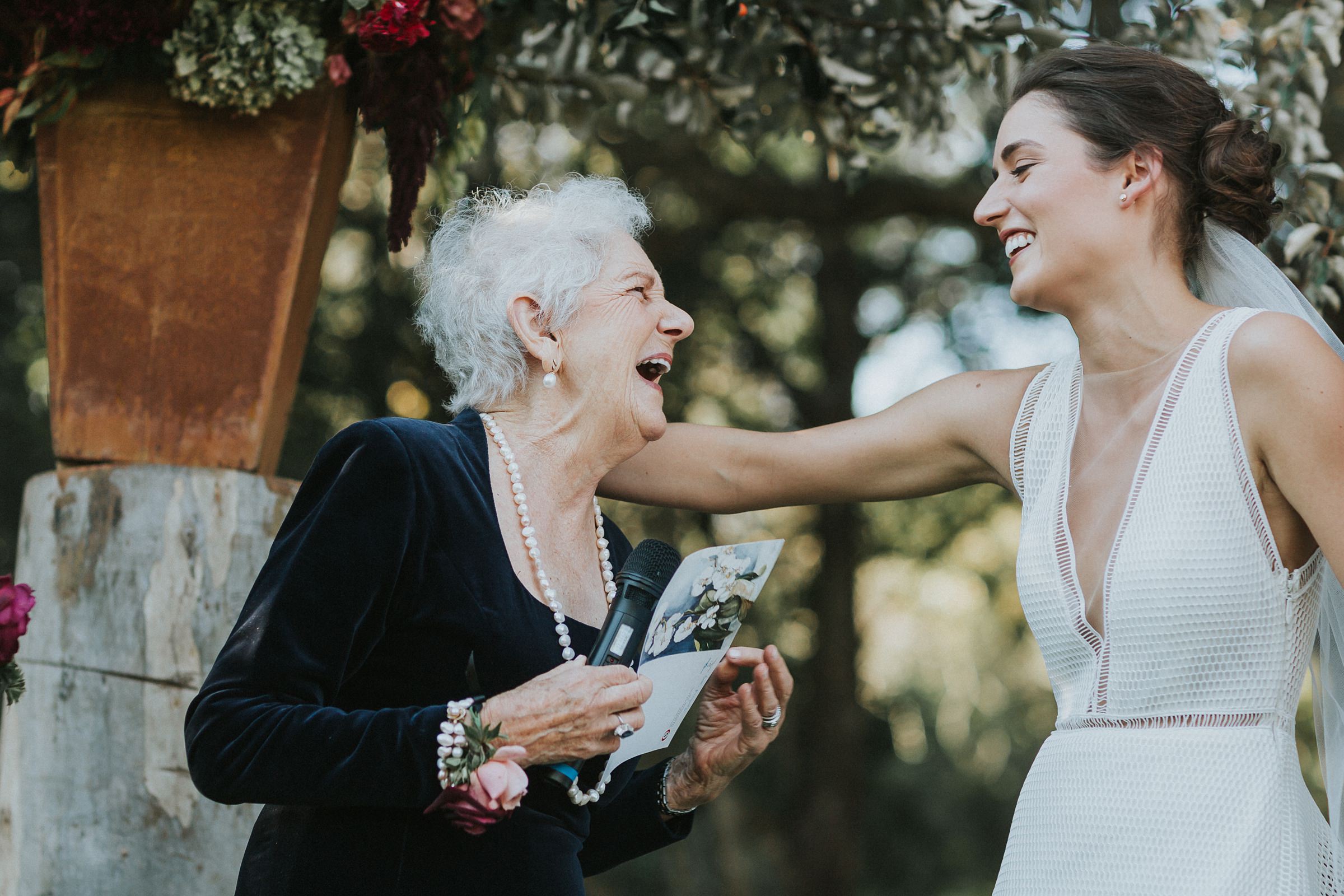 intimate embrace by bride and her grandmother during the berry wedding ceremony