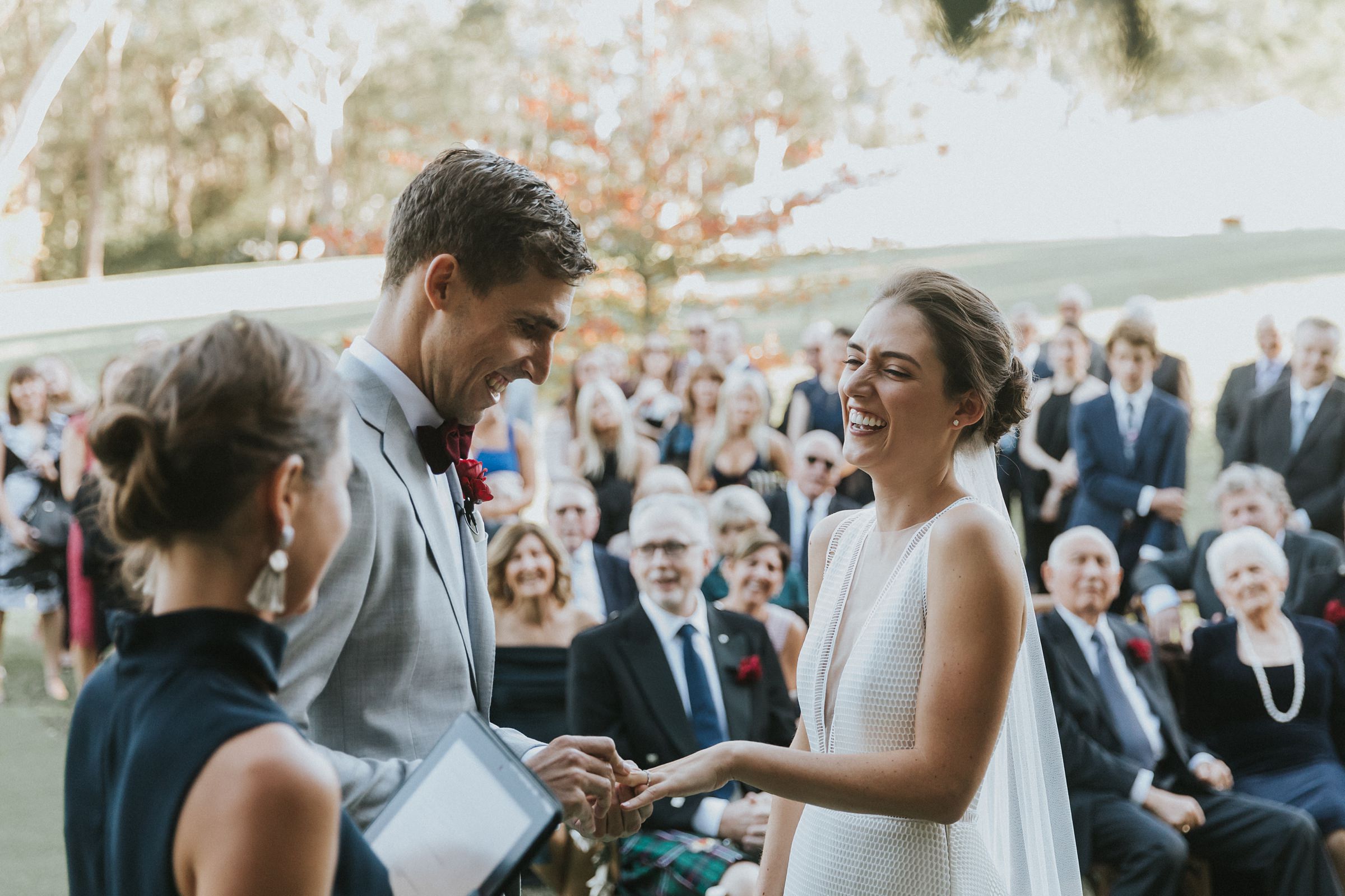 bride and groom exchange rings during wedding ceremony