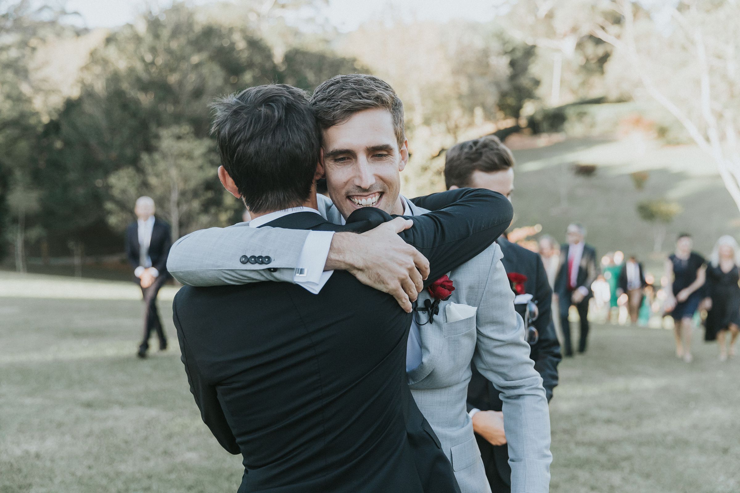 groom being congratulated by brother after wedding ceremony