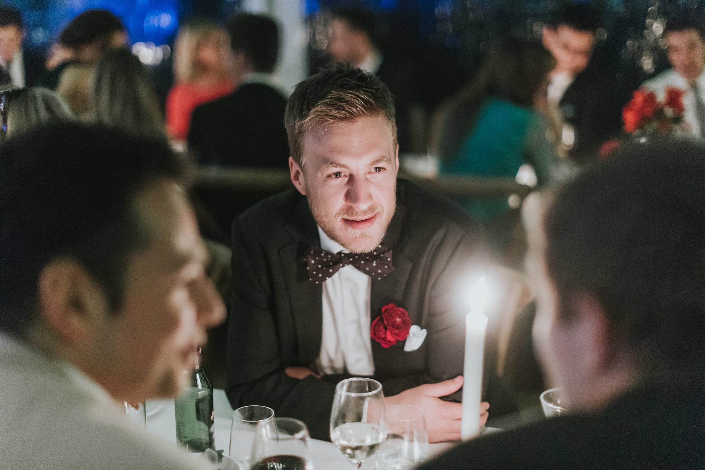 guests enjoying some quiet conversation by candlelight during marquee wedding reception in berry