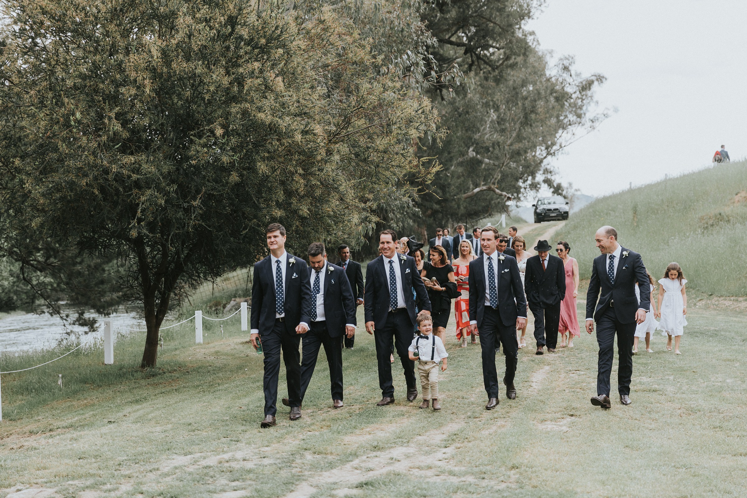 groom and guests walking to the ceremony location at nimbo fork lodge